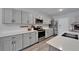 Modern kitchen features stainless steel appliances, gray cabinets, and white countertops at 12826 French Market Dr, Riverview, FL 33579