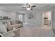 Relaxing loft space with a cozy couch, ceiling fan, and tasteful decor at 12826 French Market Dr, Riverview, FL 33579