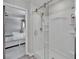Modern main bathroom with glass-enclosed shower and views into the main bedroom at 12826 French Market Dr, Riverview, FL 33579