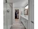 Main bathroom featuring a glass shower, walk-in closet, and double vanity at 12826 French Market Dr, Riverview, FL 33579