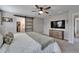 Serene main bedroom with a barn door to the bathroom, closet, and a TV above dresser at 12826 French Market Dr, Riverview, FL 33579