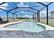 Stunning screened-in pool area with ample seating, featuring a waterfall and serene outdoor living at 12826 French Market Dr, Riverview, FL 33579