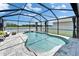 Inviting screened-in pool overlooking the lake, featuring serene outdoor living and backyard privacy at 12826 French Market Dr, Riverview, FL 33579