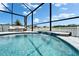 Stunning screened-in pool with a tranquil waterfall feature, offering a relaxing and luxurious outdoor experience at 12826 French Market Dr, Riverview, FL 33579