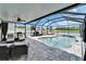 Enclosed pool area with lounge chairs, outdoor seating, barbecue, and views of the surrounding landscape at 12826 French Market Dr, Riverview, FL 33579