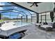 Screened pool featuring lounge furniture, comfortable seating, and privacy curtains for an ultimate relaxation space at 12826 French Market Dr, Riverview, FL 33579