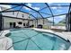 Screened-in pool with stone patio, outdoor seating, and barbecue area perfect for entertaining and leisure at 12826 French Market Dr, Riverview, FL 33579