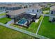 Aerial view of a private screened-in pool in a fenced backyard with manicured lawn and patio at 12826 French Market Dr, Riverview, FL 33579