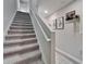 Carpeted stairway leading upstairs, with modern decor and a neutral color palette throughout at 12826 French Market Dr, Riverview, FL 33579