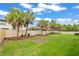Well-maintained backyard featuring a lush green lawn and neat, trimmed trees and shrubs at 13299 Wildgrass Trl, Odessa, FL 33556