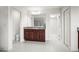 Bright bathroom features a granite-topped vanity and a mirrored wall with access to the commode and walk-in closet at 13299 Wildgrass Trl, Odessa, FL 33556