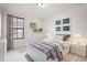 A well lit bedroom with stylish car themed decorations and a comfy grey comforter at 13299 Wildgrass Trl, Odessa, FL 33556