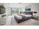 Large bedroom with two windows, neutral walls, and plush carpet flooring at 13299 Wildgrass Trl, Odessa, FL 33556