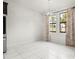 Dining room with tile floors, stylish lighting, and access to outdoor space at 13299 Wildgrass Trl, Odessa, FL 33556