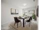 Dining room featuring a marble table, six chairs, stylish wall art and a neutral-toned rug at 13299 Wildgrass Trl, Odessa, FL 33556