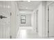 Bright hallway with neutral paint, white doors, and ample natural light at 13299 Wildgrass Trl, Odessa, FL 33556