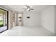 Bright living room with tile floors, large windows, and access to outdoor space at 13299 Wildgrass Trl, Odessa, FL 33556
