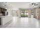 Bright and airy open concept living space with tile floors, a large island, and great natural light at 13299 Wildgrass Trl, Odessa, FL 33556