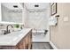 Bright bathroom featuring a jacuzzi tub, double vanity, and a modern lighting fixture at 1384 S Hillcrest Ave, Clearwater, FL 33756