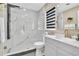 Bathroom featuring a glass shower with marble tile and a sink with a quartz countertop at 1384 S Hillcrest Ave, Clearwater, FL 33756