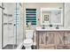 Modern bathroom with a glass shower, double vanity, and stylish fixtures at 1384 S Hillcrest Ave, Clearwater, FL 33756