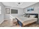 Bedroom featuring a blue bed with a cushioned bench and light hardwood floors at 1384 S Hillcrest Ave, Clearwater, FL 33756