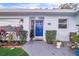Inviting entryway with a vibrant blue door and decorative plants, enhancing curb appeal at 1384 S Hillcrest Ave, Clearwater, FL 33756