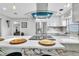 Contemporary kitchen featuring an island cooktop, marble backsplash, and sleek stainless steel appliances at 1384 S Hillcrest Ave, Clearwater, FL 33756