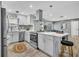 Well lit kitchen with stainless steel appliances, island, and hardwood floors at 1384 S Hillcrest Ave, Clearwater, FL 33756