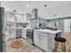 Open concept kitchen with stainless steel appliances, central island, and eat-in seating at 1384 S Hillcrest Ave, Clearwater, FL 33756