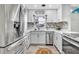 Bright kitchen features white cabinetry, modern appliances, marble backsplash, and stylish decor at 1384 S Hillcrest Ave, Clearwater, FL 33756