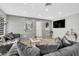 Spacious living room with stylish sofas, wood accent wall, and light hardwood floors at 1384 S Hillcrest Ave, Clearwater, FL 33756