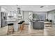 Open-concept living space featuring a modern kitchen with island seating and a comfortable gray sofa at 1384 S Hillcrest Ave, Clearwater, FL 33756