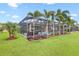 A lovely view of the pool and patio area with a well-manicured lawn and lush landscaping at 14514 Woodland Spur Dr, Lithia, FL 33547