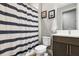 This bathroom features a shower with a striped curtain and a marble vanity at 14514 Woodland Spur Dr, Lithia, FL 33547