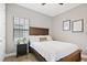 This bedroom features neutral paint and wood look floors at 14514 Woodland Spur Dr, Lithia, FL 33547