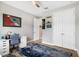 Bright bedroom features a ceiling fan, spacious closet, and white writing desk area at 14514 Woodland Spur Dr, Lithia, FL 33547
