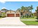 Charming single-Gathering home featuring a well-maintained lawn, a two-car garage, and a welcoming entrance at 14514 Woodland Spur Dr, Lithia, FL 33547