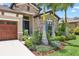 Close-up of the home's front entrance with decorative stone accents and manicured landscaping at 14514 Woodland Spur Dr, Lithia, FL 33547