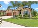 Well-maintained front yard with lush landscaping and a view of the home's facade at 14514 Woodland Spur Dr, Lithia, FL 33547
