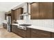 Modern kitchen featuring stainless steel appliances, a gas range, and stylish tile backsplash at 14514 Woodland Spur Dr, Lithia, FL 33547