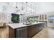 Kitchen island with sink and dishwasher overlooking living and dining areas at 14514 Woodland Spur Dr, Lithia, FL 33547