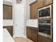 Kitchen showcasing stainless steel microwave and oven appliances with wood cabinets and tile backsplash at 14514 Woodland Spur Dr, Lithia, FL 33547