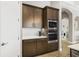Kitchen with built-in microwave and oven, wood cabinets, and modern finishes at 14514 Woodland Spur Dr, Lithia, FL 33547