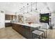 Open concept kitchen with a large island and seating overlooking the living area at 14514 Woodland Spur Dr, Lithia, FL 33547