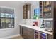 Kitchen bar area with built-in beverage coolers, cabinets, and wine storage at 14514 Woodland Spur Dr, Lithia, FL 33547