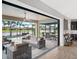 Outdoor living area features an outdoor pool, lake view, and comfortable seating for relaxation and entertainment at 14514 Woodland Spur Dr, Lithia, FL 33547