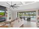 Bright open living room with seamless transition to the outdoor lanai, showcasing the pool and waterfront view at 14514 Woodland Spur Dr, Lithia, FL 33547