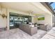 Outdoor patio with comfortable seating and large sliding glass doors to the interior at 14514 Woodland Spur Dr, Lithia, FL 33547