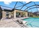 A spacious screened patio with pool access, an outdoor kitchen, and comfortable seating for relaxation at 14514 Woodland Spur Dr, Lithia, FL 33547
